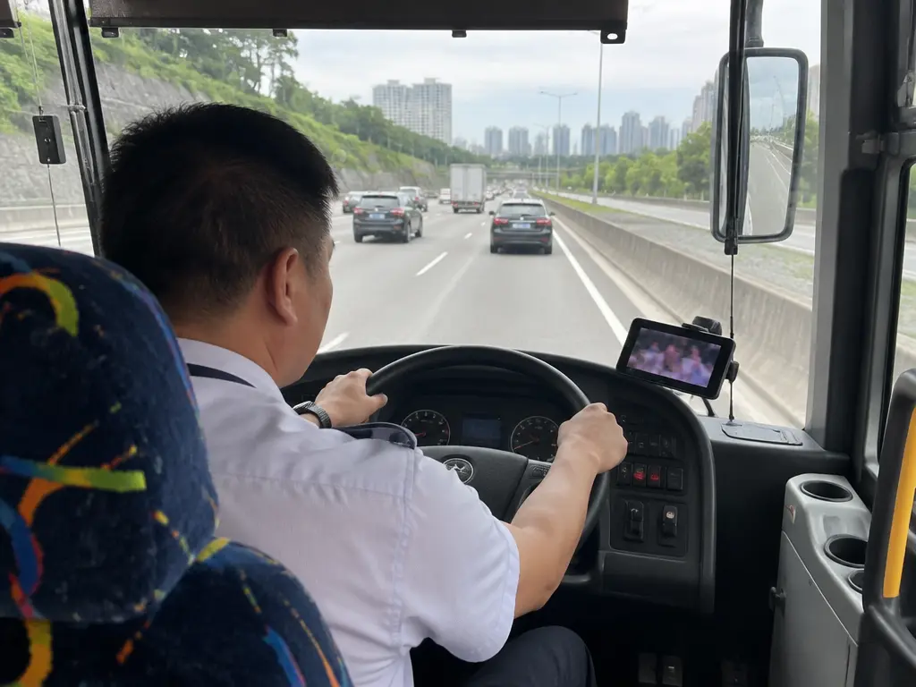 示意图：长巴司机驾驶时，右侧放着一部亮着屏幕的手机。